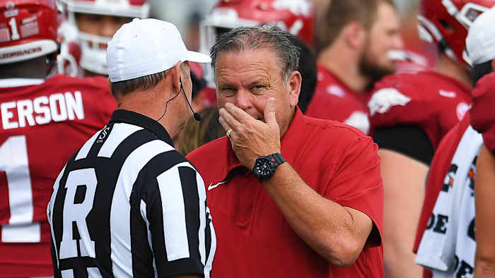 Razorbacks coach Sam Pittman talking with an official during a game at Razorback Stadium